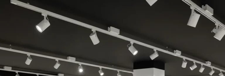 White track run with aimed spotlights across a retail store ceiling